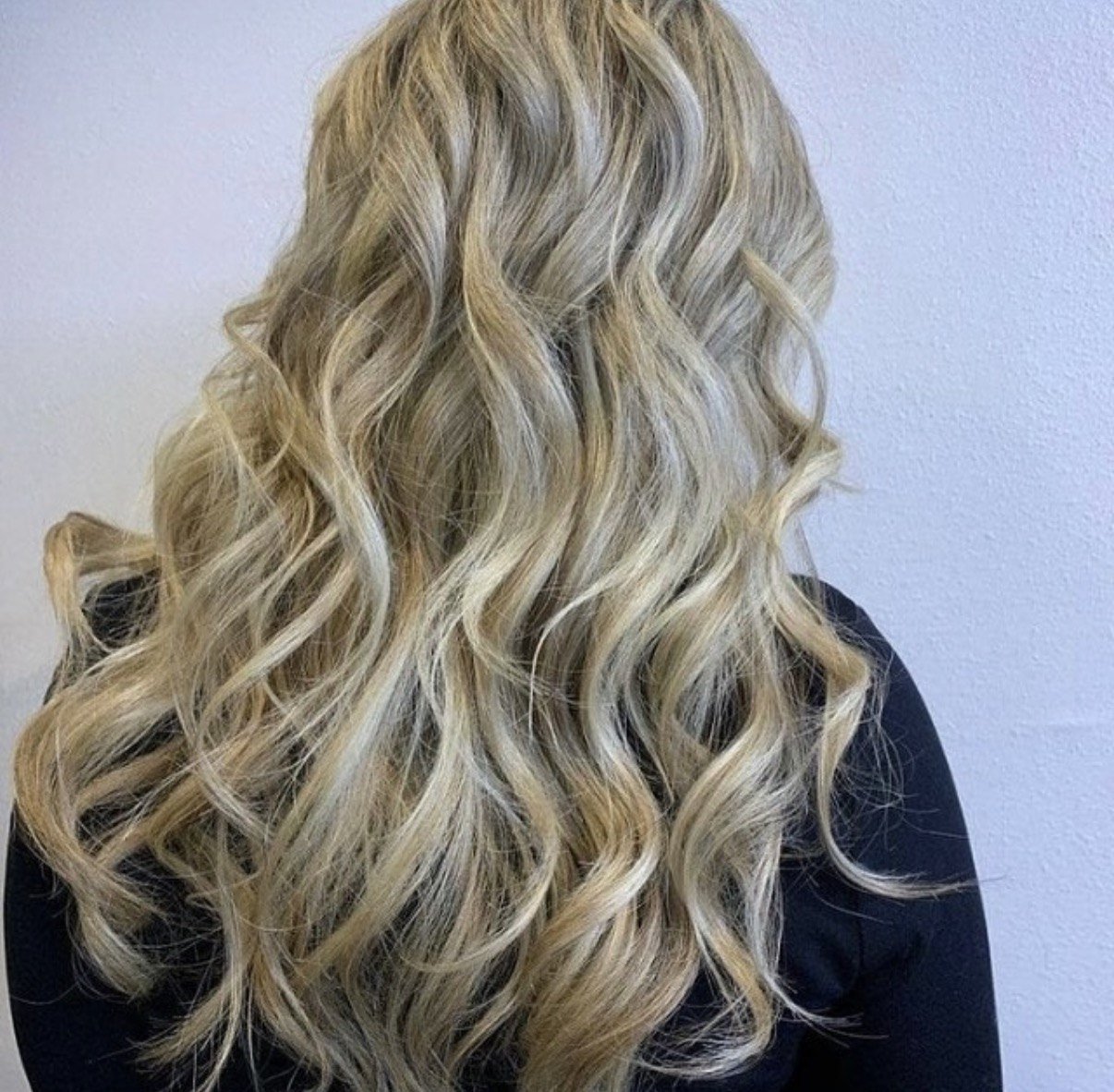 Bright buttery blonde highlights with soft waves