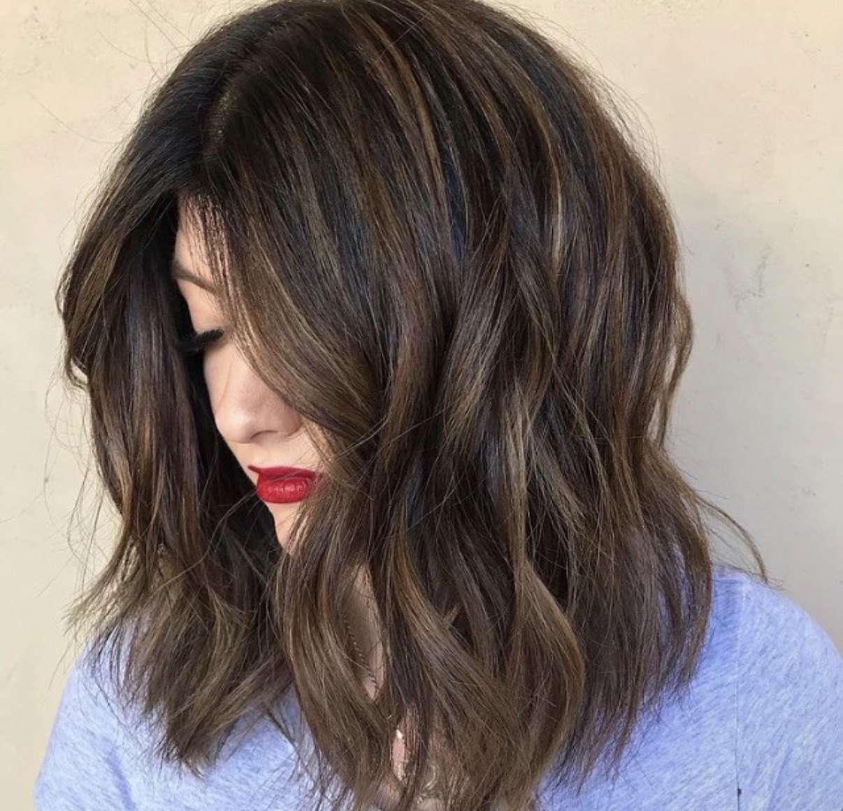 Dimensional brunette color paired with a lived-in textured cut