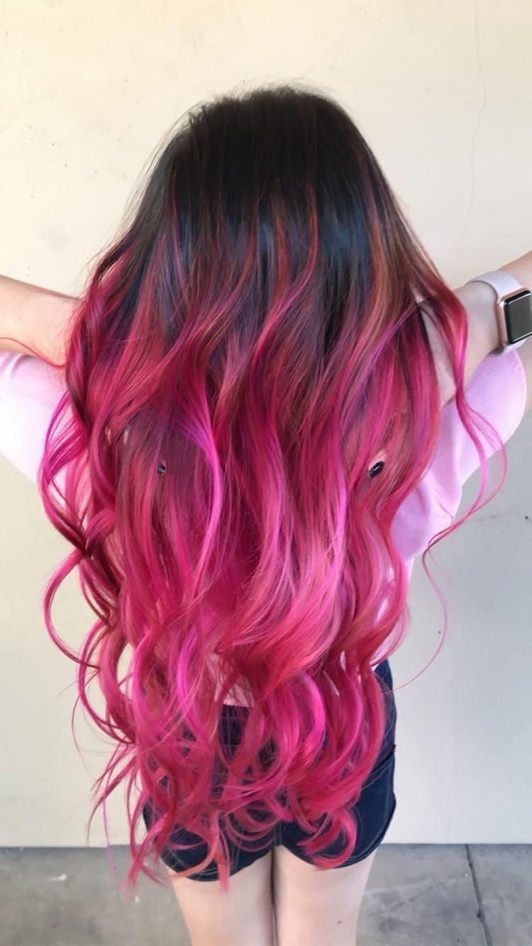 Hot pink and magenta vivid ombre melting from a dark root