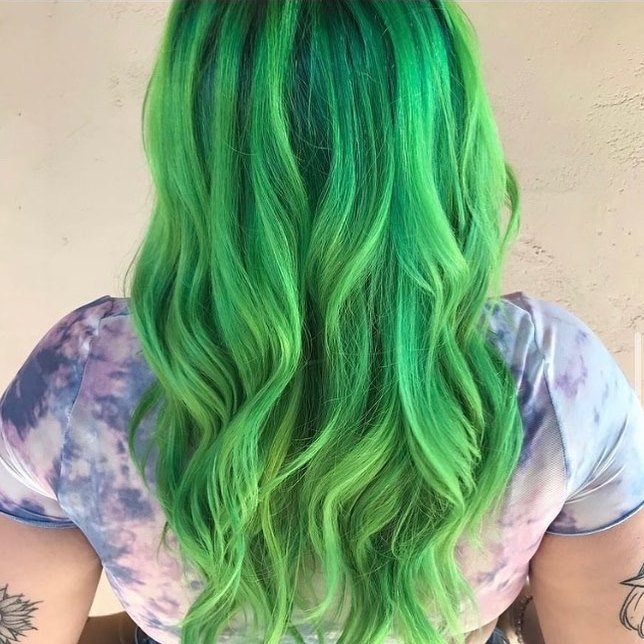 Bold neon green vivid hair color with glossy waves by Caitlin Richards