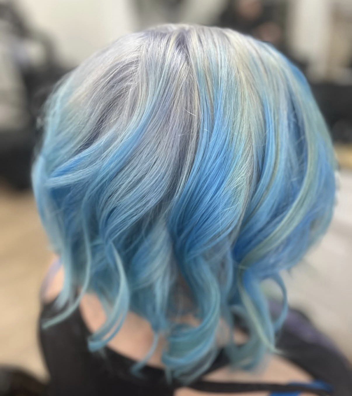Pastel blue and silver vivid color on a textured curled bob