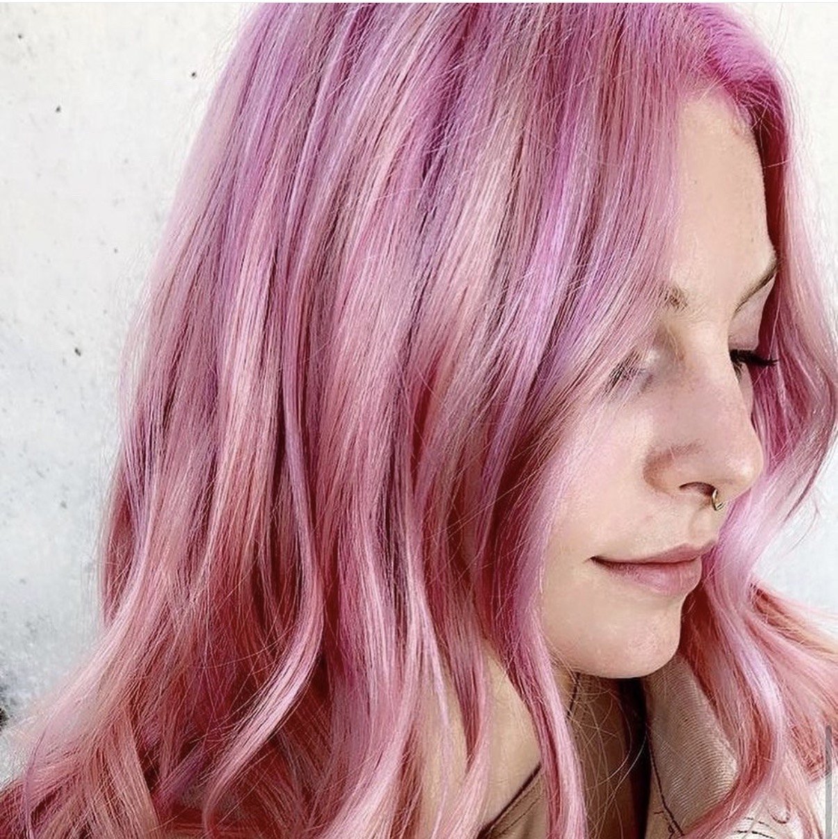 Client smiling with soft pastel pink vivid hair color