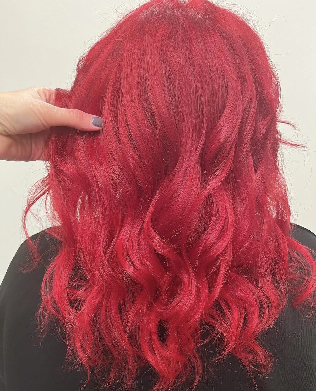 Saturated vivid red hair color with high-shine curls