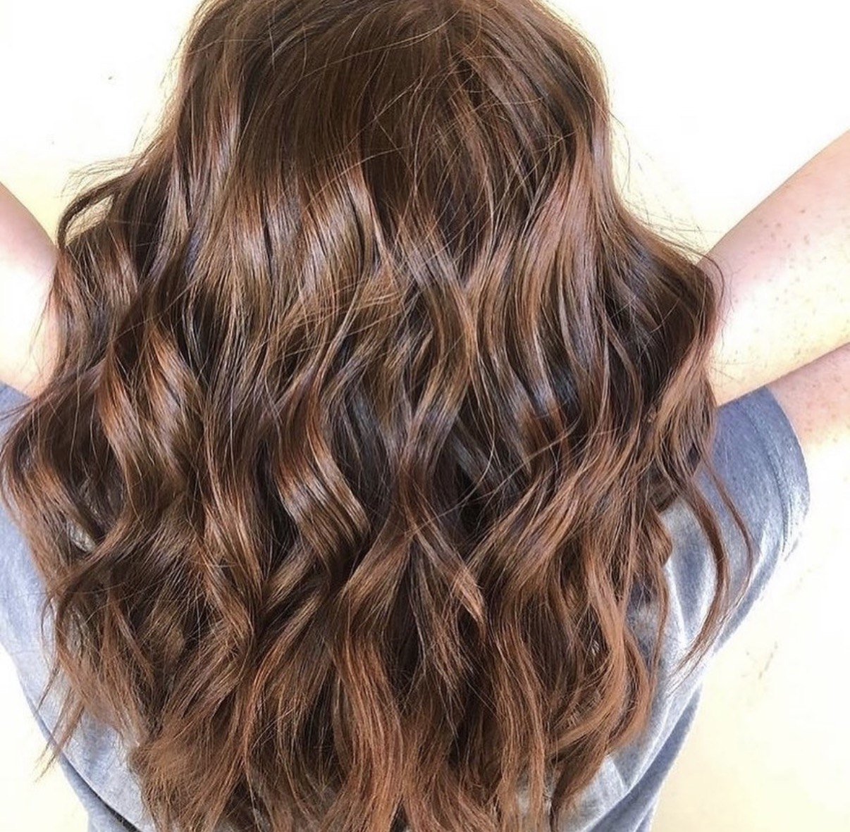 Warm brunette hair with copper balayage ribbons
